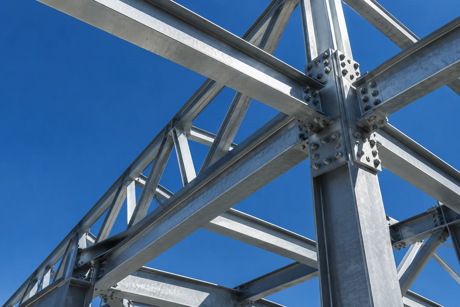 Conceptual view of precision steel connections and intersecting beams against a blue sky
